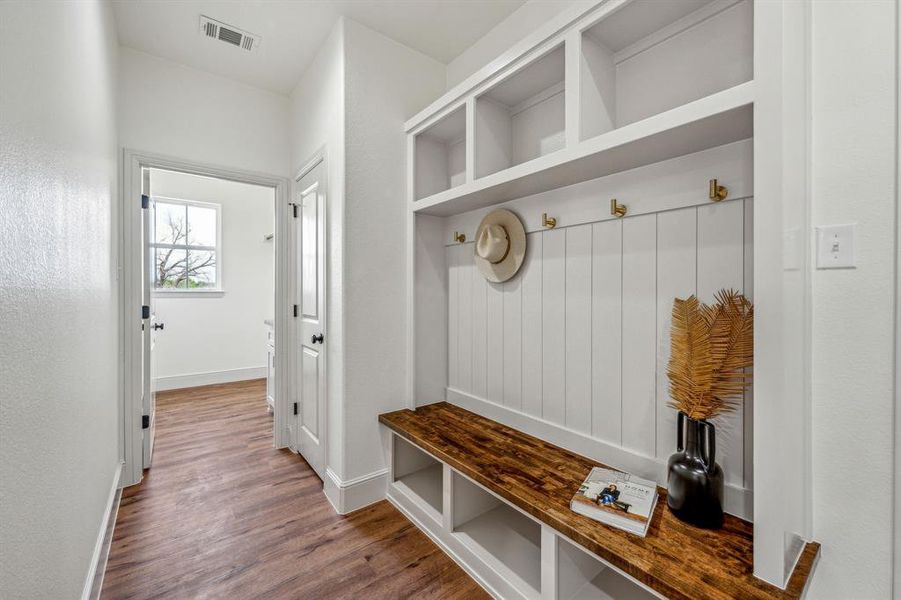 Mudroom with wood-type flooring