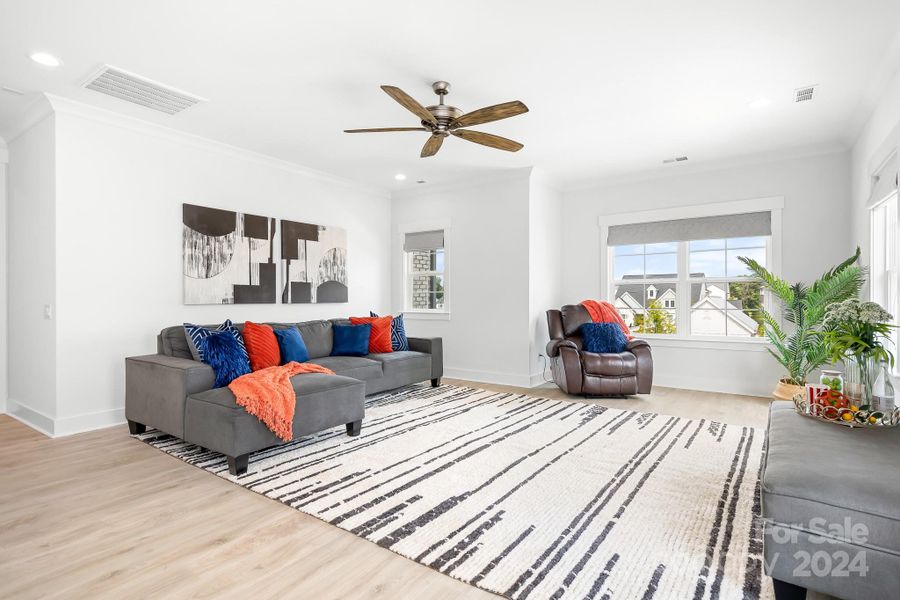 Large loft area at the top of the stairs.  Look at all the natural light coming in from the windows.