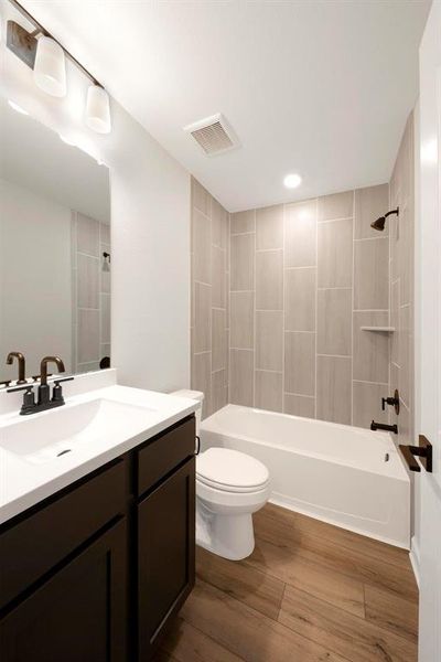 In the secondary bathroom, a modern vanity adds elegance and functionality, while the tub-shower combo offers the best of both worlds.
