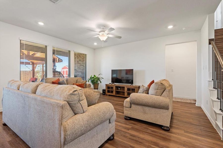 Living room featuring ceiling fan and dark hardwood / wood-style floors