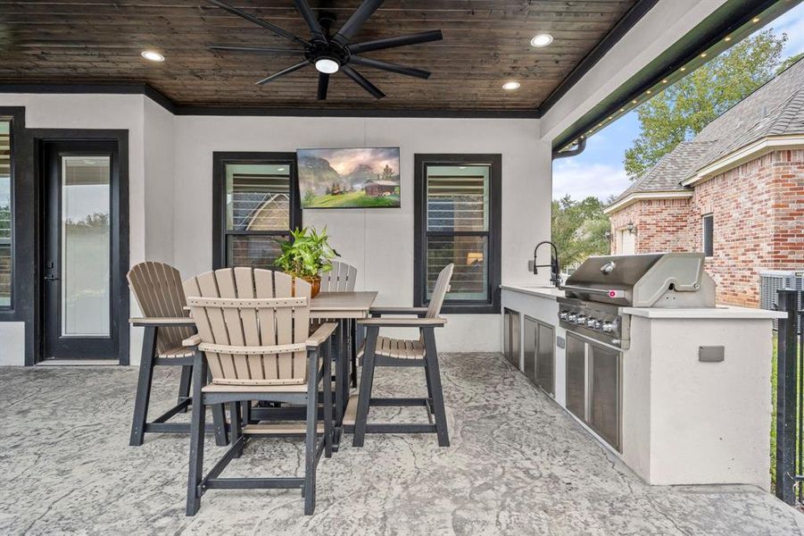 Outdoor living space is complete with natural gas connections to the grill, quartz countertops and undermount sink, and plenty of storage. Mounted wall TV is included