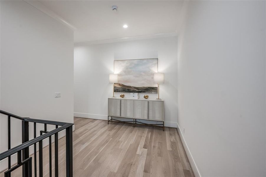 The spacious second floor hallway offers the continuous white oak floors and wall space for art.