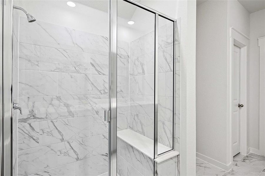 Bathroom with tile patterned flooring and a shower with door