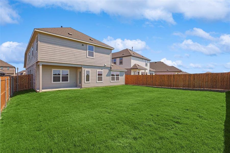 Rear view of property featuring a yard