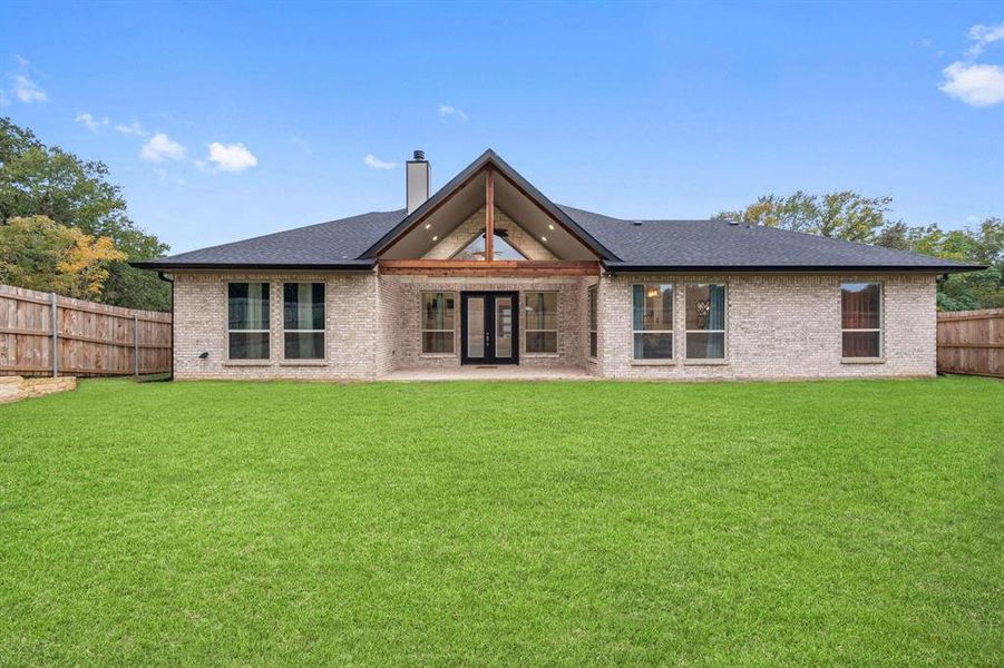 Back of house featuring french doors and a yard