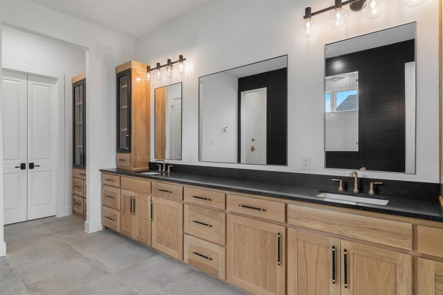 Bathroom featuring tile patterned flooring and dual vanity