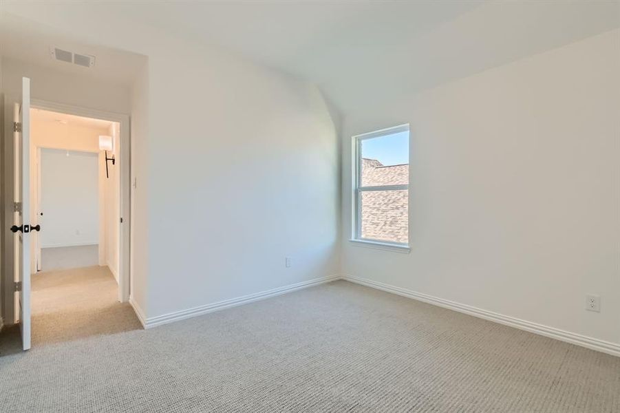 Unfurnished room featuring light colored carpet