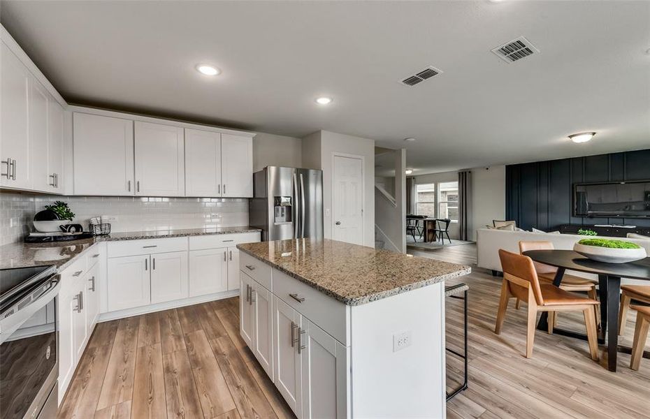 Spacious kitchen with eat-in bartop island *Photos of furnished model. Not actual home. Representative of floor plan. Some options and features may vary.