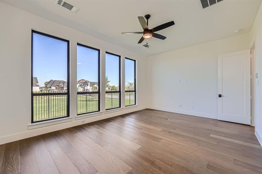 Spare room featuring ceiling fan and hardwood / wood-style flooring