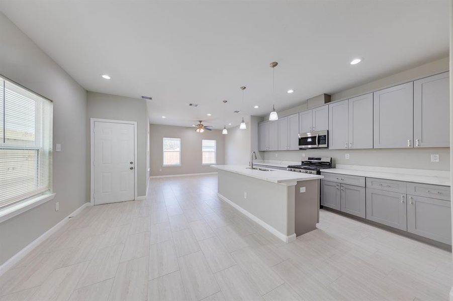 Step into the sleek, modern kitchen, where brand new stainless steel appliances perfectly complement the stylish grey cabinetry. This contemporary space blends functionality with elegance, offering a clean and polished look that’s both practical and visually stunning. Whether cooking a quick meal or preparing for a gathering, this kitchen is equipped to meet all your needs with style.