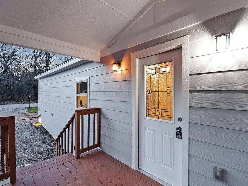 Doorway to property featuring a wooden deck