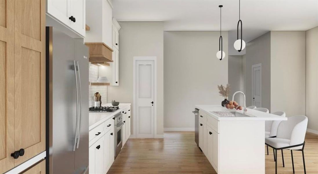 Kitchen featuring decorative light fixtures, stainless steel appliances, white cabinets, light hardwood / wood-style floors, and a kitchen island with sink