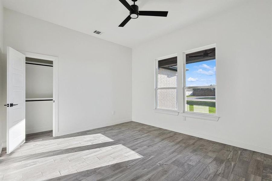 Unfurnished bedroom with ceiling fan, a closet, and light hardwood / wood-style floors