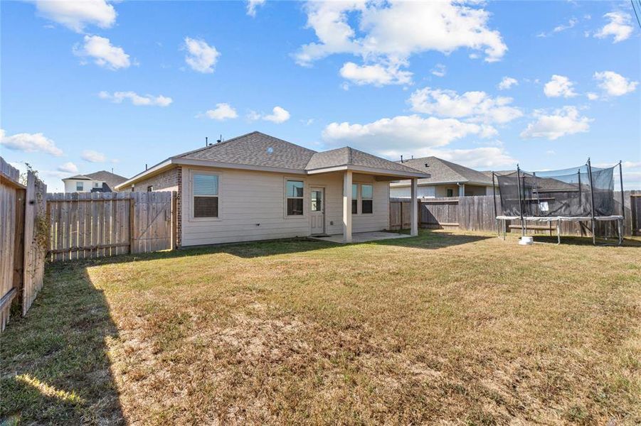 Spacious backyard with covered back porch.