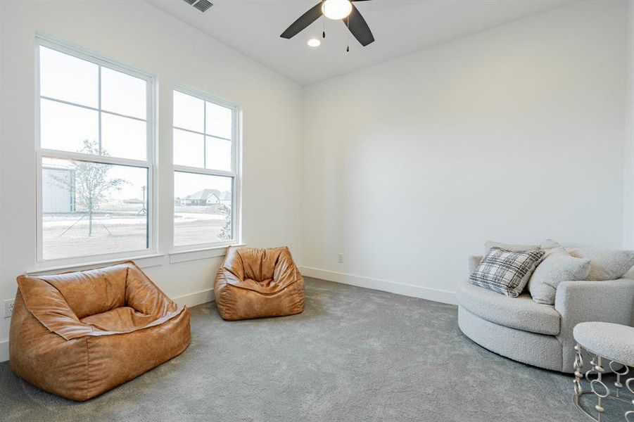 Bedroom featuring ceiling fan and carpet floors