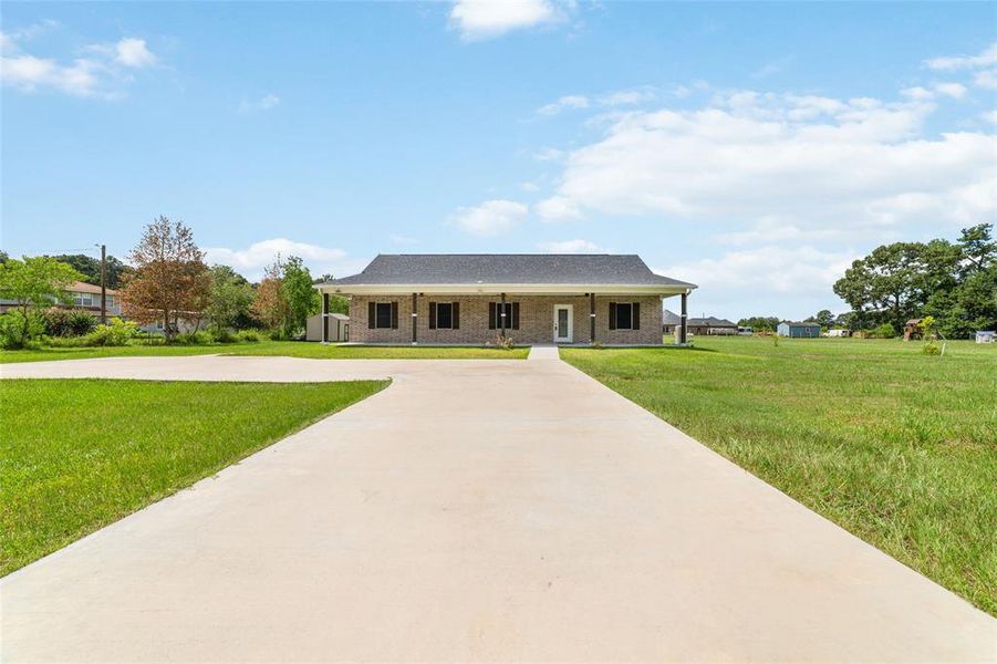 Nestled amidst lush green grass, this home boasts an oversized driveway leading directly to the front door. The meticulously paved expanse adds a touch of grandeur to your entrance.