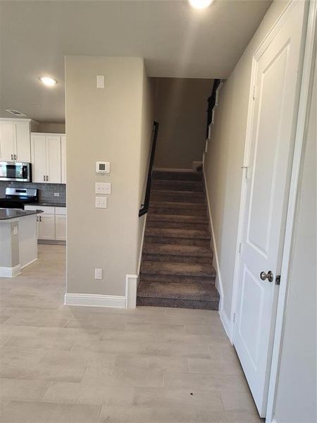 Stairs with hardwood / wood-style floors