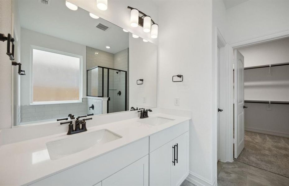 Owner's bath with dual vanity and oversized shower*real home pictured