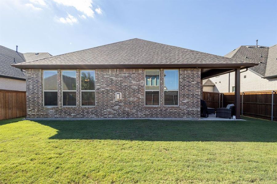 Back of property with a patio and a yard