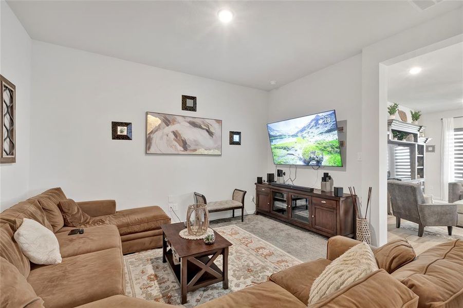 Flowing Layout - Peek into the family/living room to the right, showcasing the space and flow of the home’s layout.