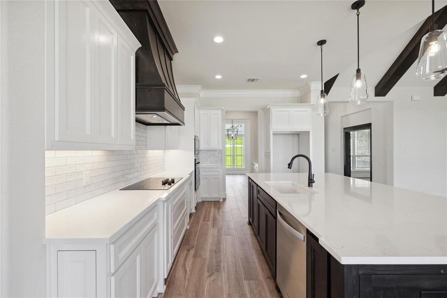 Kitchen featuring black appliances, white cabinets, sink, custom range hood, and light hardwood / wood-style flooring