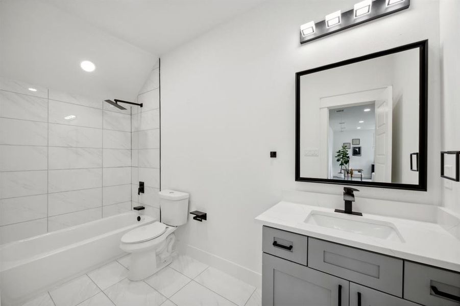 2nd floor bathroom with tile patterned flooring, toilet, vanity, and tiled shower / bath