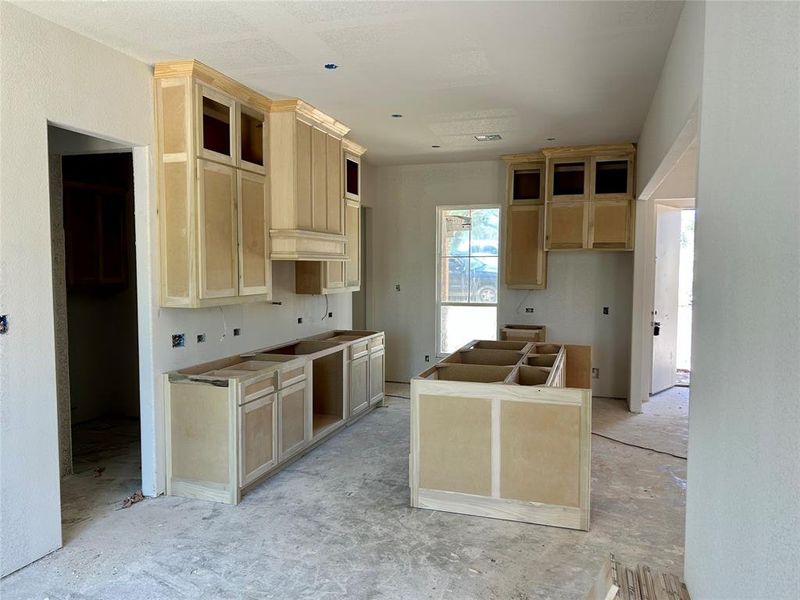 Kitchen with light brown cabinets and a kitchen island
