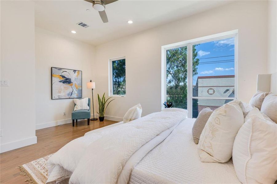 Bedroom with hardwood / wood-style floors and ceiling fan