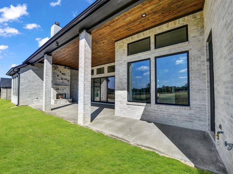 Doorway to property featuring a patio and a lawn