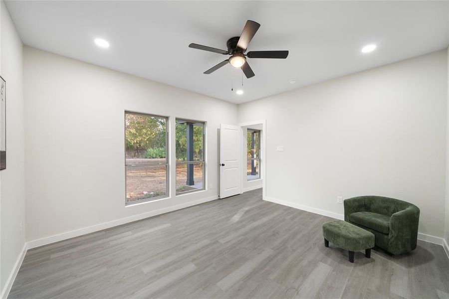 Unfurnished room featuring light wood-type flooring and ceiling fan