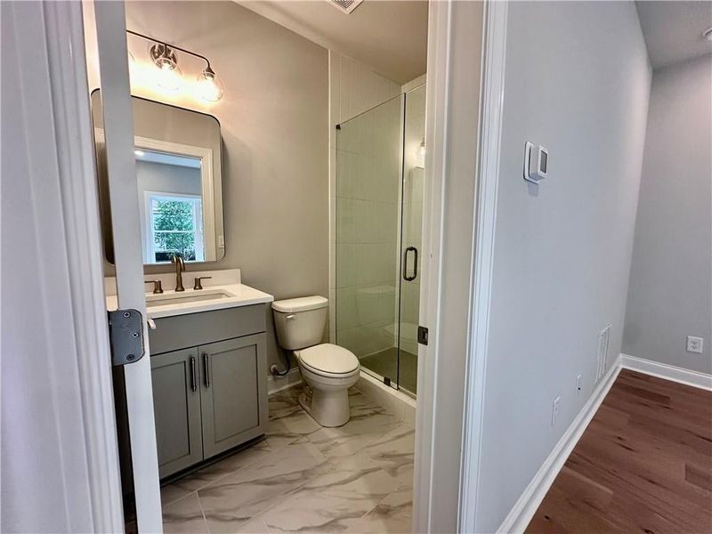 Fourth bedroom features full bathroom with upgraded walk-in shower