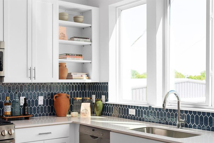 Sunlit kitchen featuring ample counter space and a breakfast bar with a view.