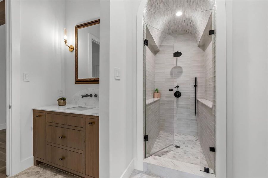 Bathroom with a shower with shower door and vanity