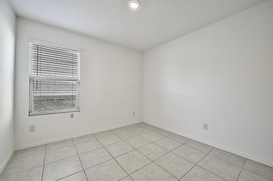 Empty room with light tile patterned floors