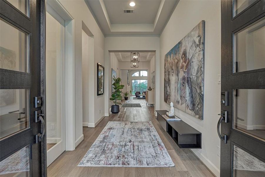 Enjoy the warmth of exquisite hardwood floors complemented by beautiful lighting fixtures throughout, creating a stylish and inviting ambiance.