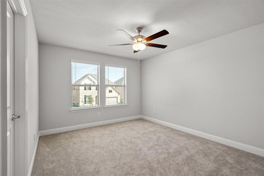 Unfurnished room with light carpet and ceiling fan