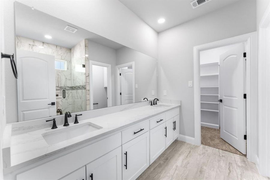 Bathroom with wood-type flooring, walk in shower, and vanity