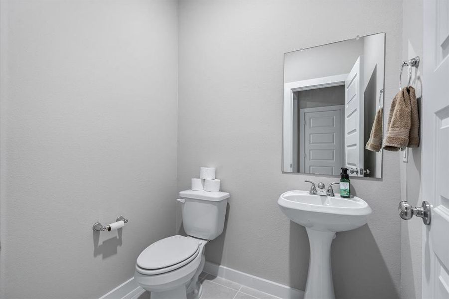 Bathroom featuring tile floors and toilet