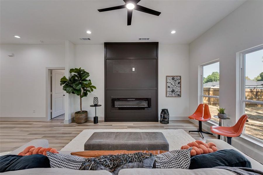 Living room featuring an electric fireplace