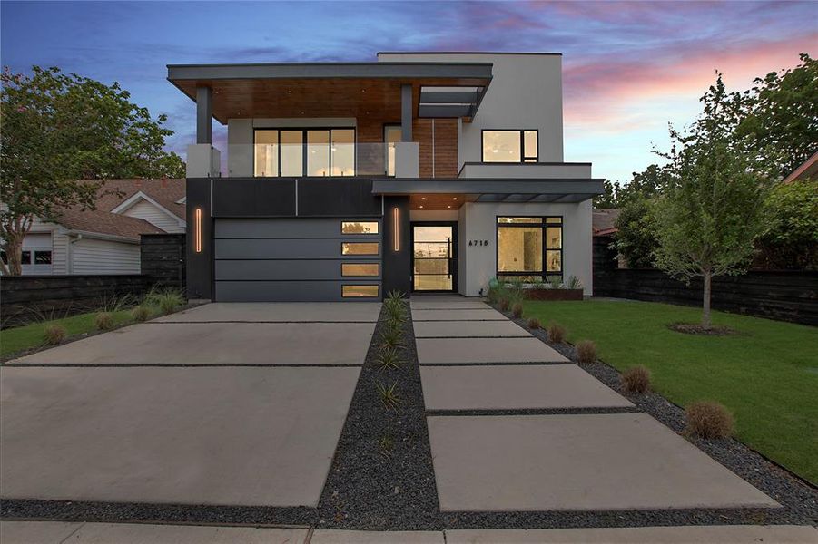 Contemporary home with a garage and a yard