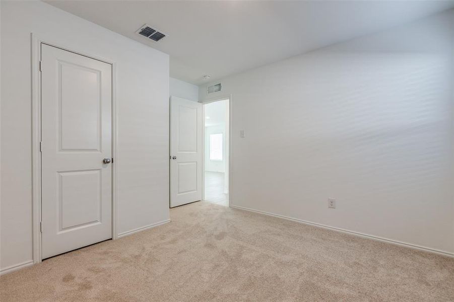 Unfurnished bedroom featuring light carpet