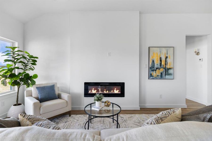 Living room featuring lofted ceiling and hardwood / wood-style flooring