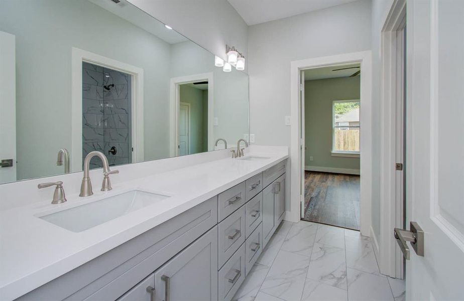 This striking jack and Jill bathroom comes fully equipped with dual sinks