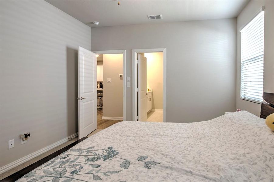 Bedroom featuring ensuite bath and hardwood / wood-style flooring