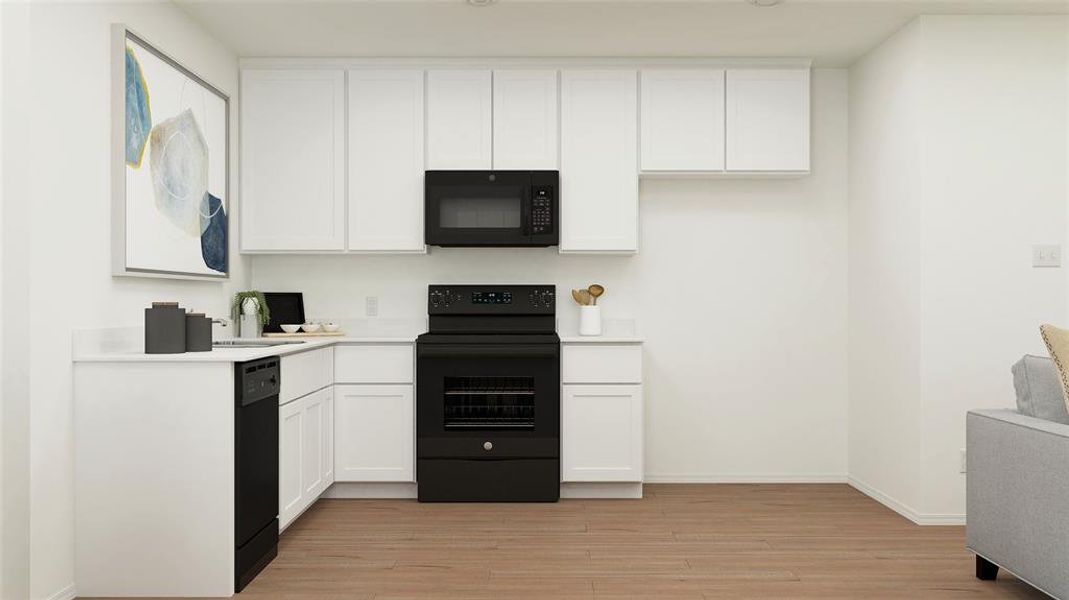 Kitchen featuring light wood-type flooring, black appliances, white cabinetry, and sink