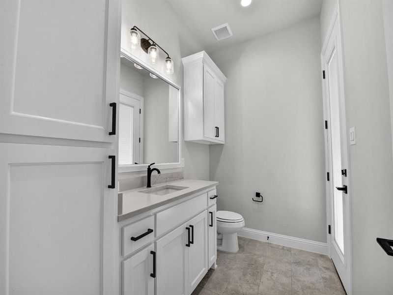 Bathroom featuring vanity and toilet