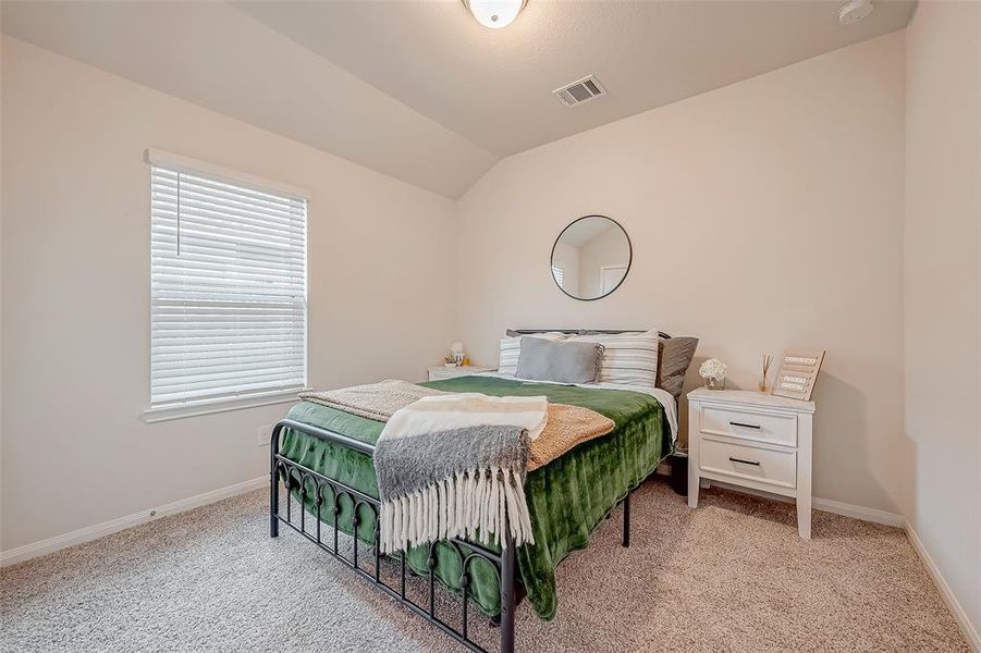 One of 2 additional bedrooms- spacious enough for a queen size bed. Third bedroom not pictured, currently used as storage.