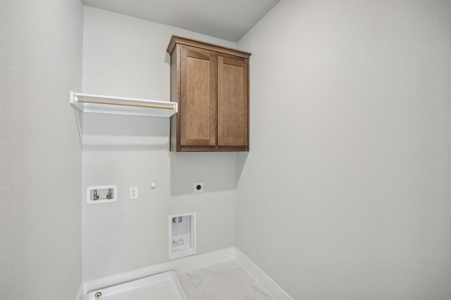 Washroom featuring washer hookup, cabinets, gas dryer hookup, and electric dryer hookup