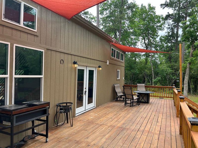 Spacious back deck is the perfect place to enjoy a quiet moment while drinking a cup of coffee or host a lively party for guests.