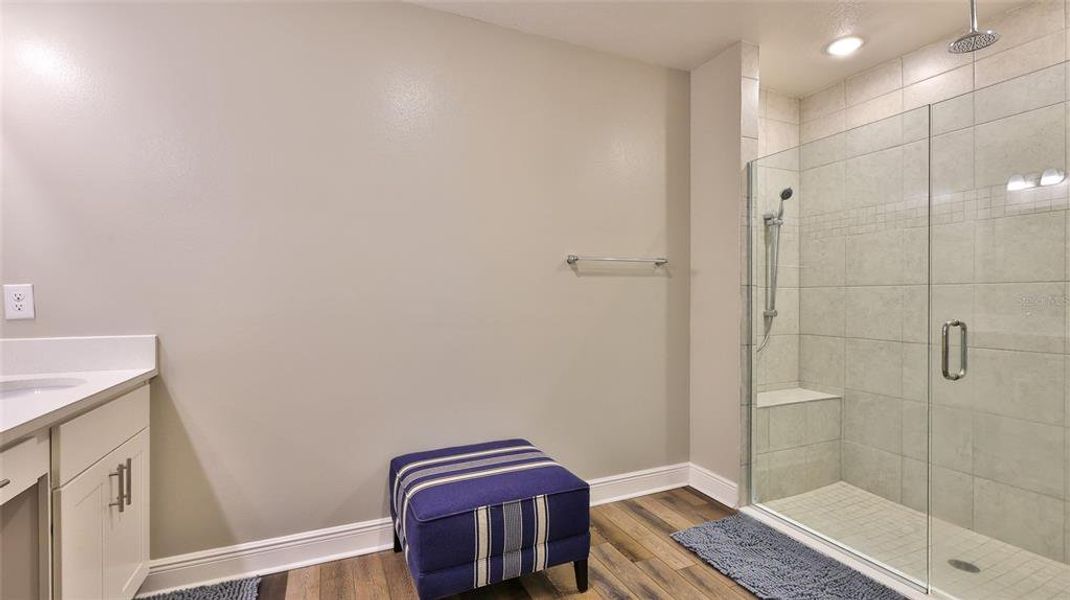 Primary bath shower with 3 shower heads, glass doors